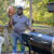 recteq customer service representative, Travis Mitchem, at home on his deck grilling on his RT-340 and holding a football