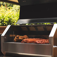 The RT-590 with the lid open to where you can see that there are 2 racks of ribs and a whole chicken on.