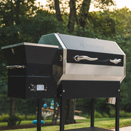 RT-590 wood pellet grill in a backyard with the sun setting and the temperature set to 350°F.