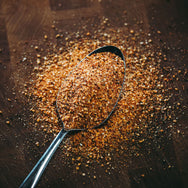 Rossarooski's Honey Rib Rub on spoon showing the spice out of bottle.