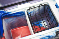 Inside of 20 quart Red, White, and Blue RECTEQ ICER cooler with integrated cutting board/divider and storage basket in use.