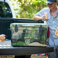 45qt. Camouflage RECTEQ ICER cooler closed and on a truck tailgate. 